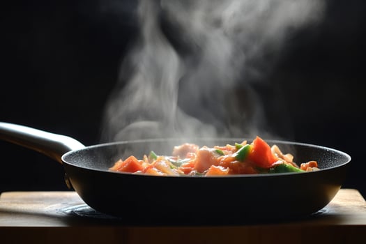 A pan with food cooking on top of a wooden table photo