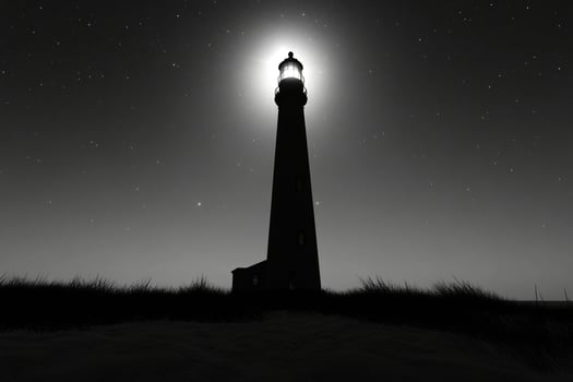 A black and white photo of a lighthouse at night