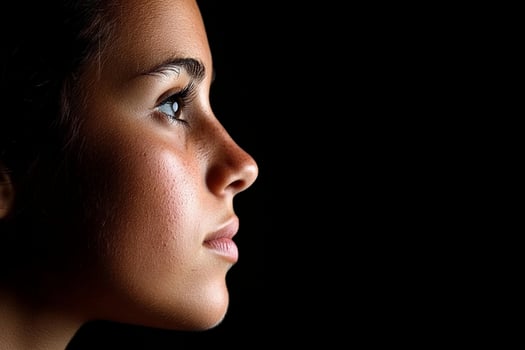 A woman's profile is shown in the dark photo