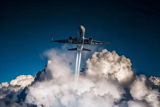 Passenger airplane soaring above dramatic clouds photo