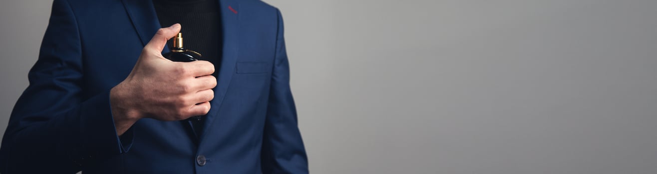 A man in a suit holding a cigarette photo