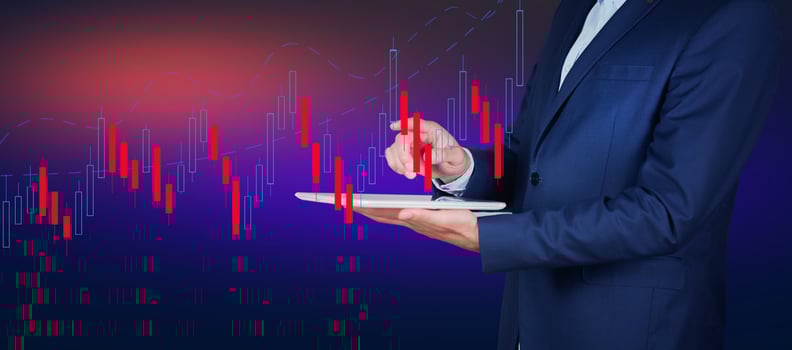 Businessman holding tablet with stock chart on background photo