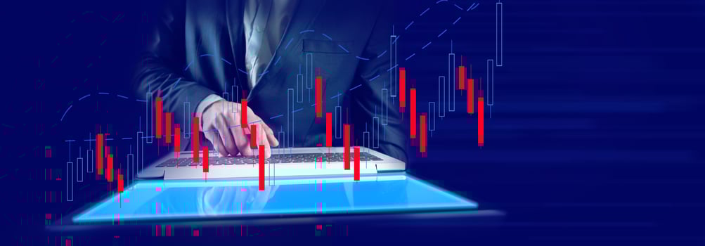 A man in a suit is using a laptop computer with a graph on it photo