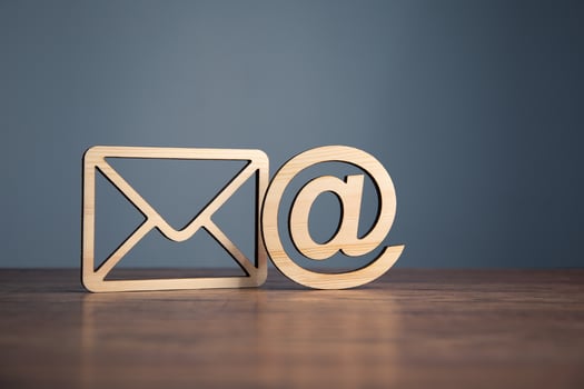 Email and email symbol on wooden table photo