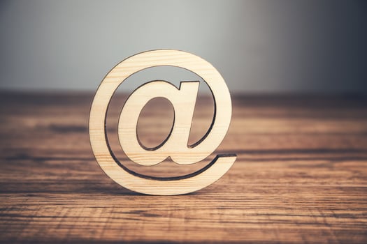 Email symbol on wooden table photo