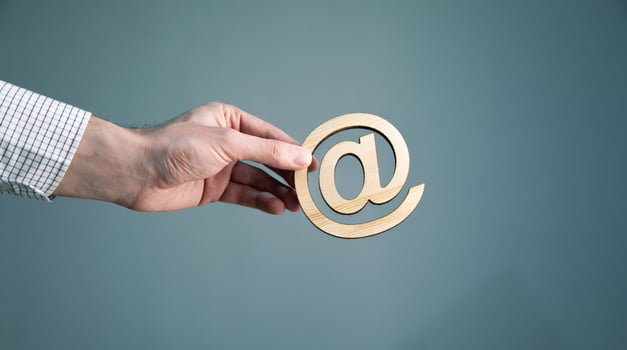 Man holding email sign on blue background photo