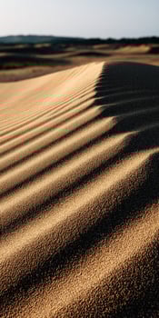 Dramatic shadows across the sandy dunes of the desert landscape photo