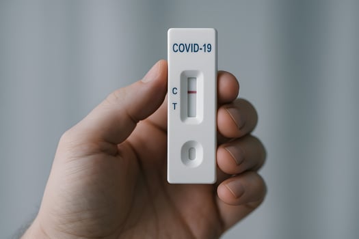 Hand holding negative COVID-19 rapid test indoors, home health check, pandemic prevention and healthcare safety concept photo