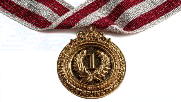 Gold medal with red and silver ribbon showcasing first place achievement in sports or competition photo