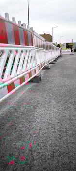 On the asphalt road in the city there is a road barrier photo