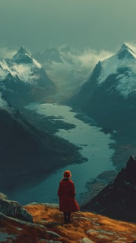 Stunning mountain landscape with a solitary figure gazing at a winding river during twilight in a serene location photo