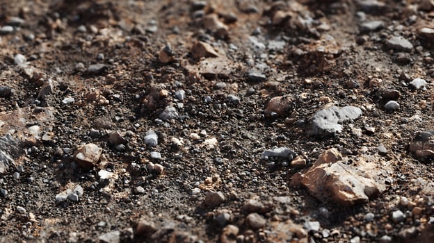 Detailed view of rocky ground surface showcasing earthy textures and mineral compositions in natural light photo
