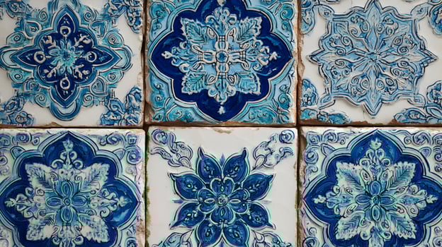 Handcrafted artistic blue and white ceramic tiles displaying traditional floral and geometric patterns photo