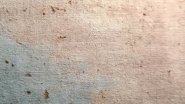 Detailed close up of an aged canvas texture with subtle color variations and organic speckling throughout its surface adding depth photo