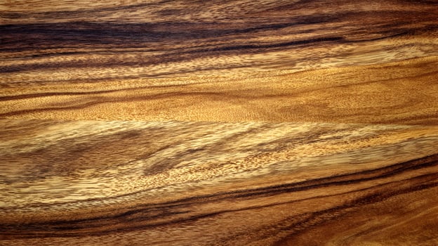 Detailed close up of a textured wood surface showcasing natural patterns and warm, rich colors creating a rustic aesthetic photo