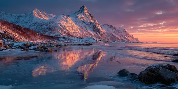 Snow-covered mountains reflect in tranquil waters at sunset in the Arctic landscape of northern Norway photo
