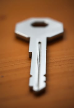 close up of a key on a wooden surface photo