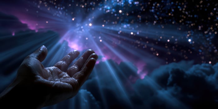Hands reaching out to the cosmos under a starry night sky filled with vibrant colors and light rays photo