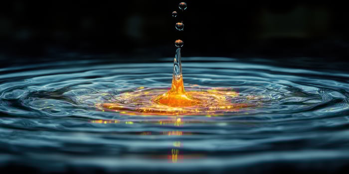 water drop with a yellow light on top photo