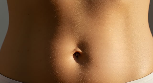 A serene image showing a woman midsection, symbolizing gentle body care, great for beauty blogs, product promotions, or wellness editorials. photo