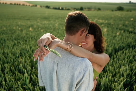 Closeness of the people, embracing. Lovely couple are on the agricultural field together photo