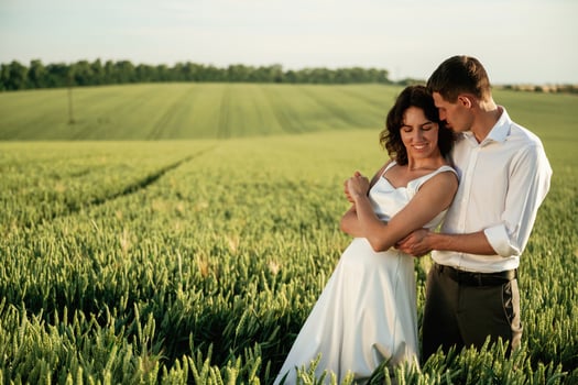 In, formal ,wedding clothes. Lovely couple are on the agricultural field together photo