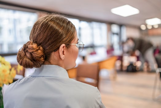 Woman hair bun, Clinic. Patient awaits check-up in clinic's waiting room during the daytime for appointment. photo