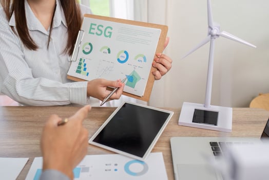 ESG Presentation. Business professionals analyzing data and discussing renewable energy models. photo