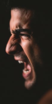 Man screaming in darkness showing powerful intense emotion photo