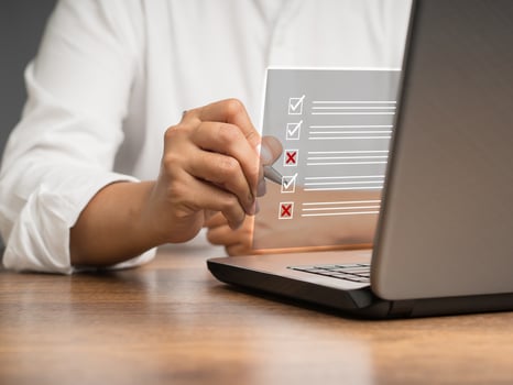 Businessman is making a checkmark and a cross symbol on a document management system or DMS on a virtual screen photo