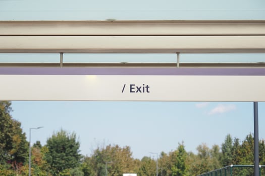 Clear exit sign at public transportation station in daylight photo
