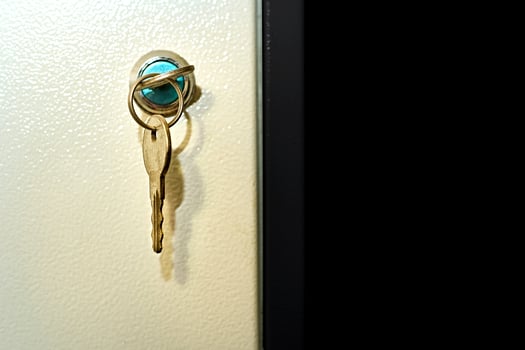 Keys in the door of a metal cabinet, black space for text photo