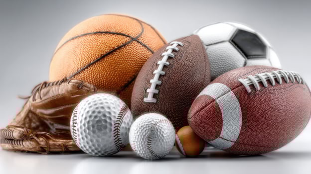 Collection of various sports balls and equipment arranged artistically on a neutral background photo