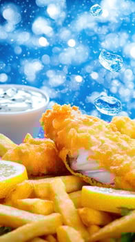 Fish and Chips with Sauce and Lemon Wedges on Blurred Blue Bokeh Background, advertisement photo