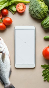 Fish and vegetables around mobile screen. Healthy eating. Cooking ingredients photo