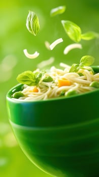 Pasta dish with veggies basil served in a green bowl fresh ingredients falling. Food photography photo