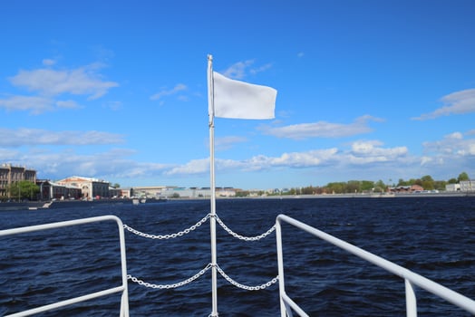 A Serene River Journey unfolds under Cloudy Skies, highlighted by a White Flag fluttering gently photo