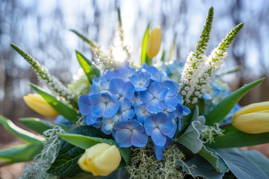 Stunning floral arrangement showcasing blue hydrangeas and yellow tulips, perfectly composed. photo