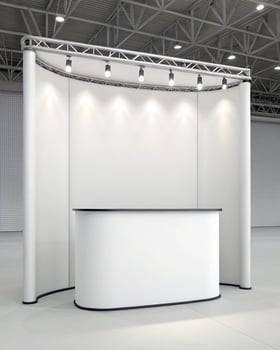 A white display booth with a counter and lights photo