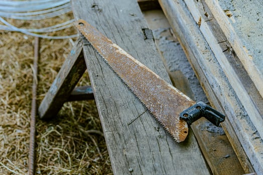 A saw blade laying on a wooden bench photo