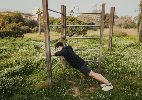 Man Works Out in Spring Outdoors Doing Push Ups photo