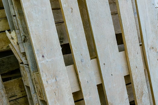 A cat sitting on a pile of wood photo