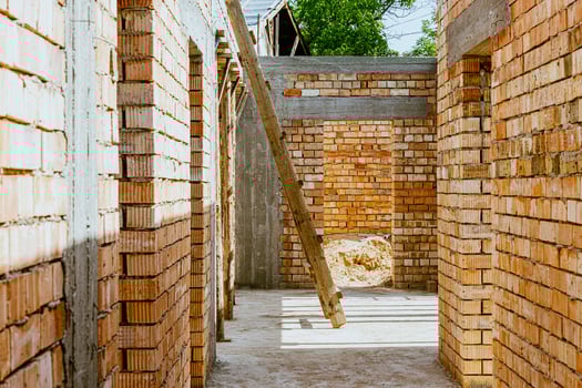 A brick wall with a ladder and a window photo