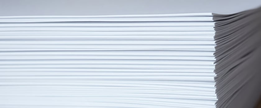 A stack of white paper on a table photo