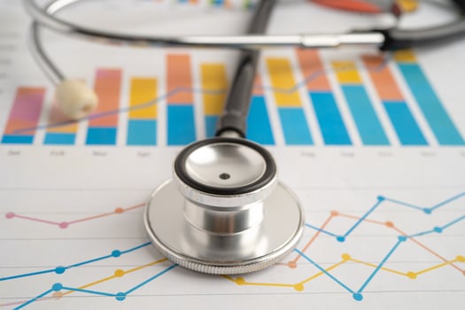 Stethoscope on spreadsheet and graph paper. photo