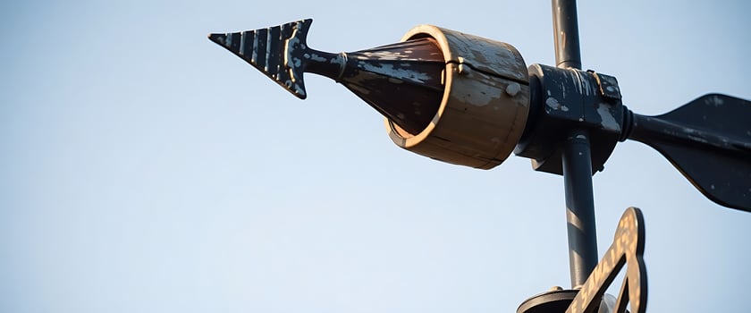 A weather vane with a metal arrow photo