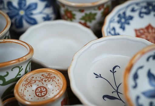 Many different types of ceramic dishes and cups photo
