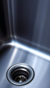 close up of a metal sink with a drain photo