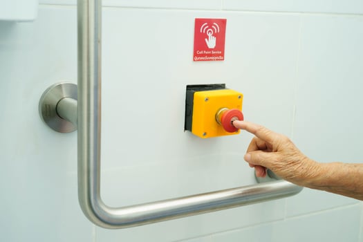 Asian elderly woman press emergency button in toilet. photo