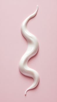 Creamy White Swirl on Pink Surface Creating a Smooth Texture and Visual Appeal photo